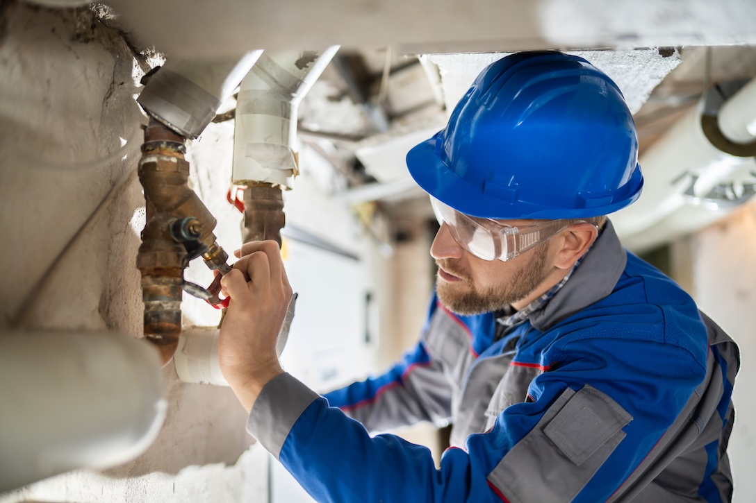 Male worker inspecting water pump problems