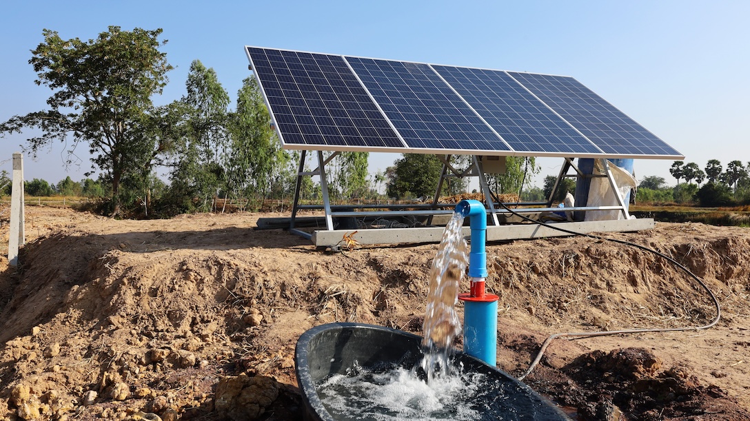 Image of an outdoor water pump and solar panels
