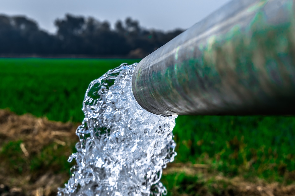 Close-up image of a water pump with flowing water