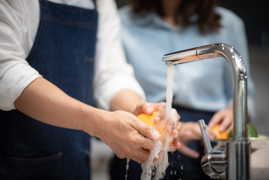 Washing vegetables and fruits for household hygiene.
